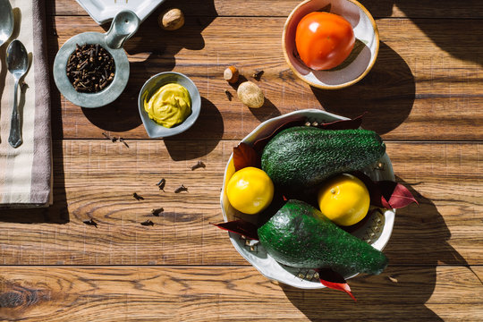 Avocados, Tomatoes and Spices on a Wooden Table