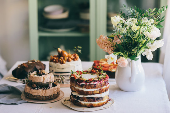 Cakes and flowers on a table