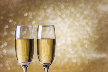 Toast champagne, new year, golden bokeh background