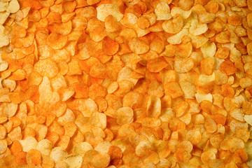 Chips potato texture. Large background of golden chips