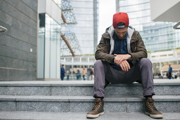 Young man sitting on a staircase