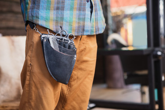 Midsection Of Hairdresser With Tools In Bag