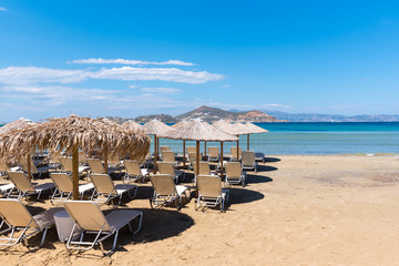 Parasols and sunbeds on Agia Anna beach, very popular resort with fine golden sand and crystal...