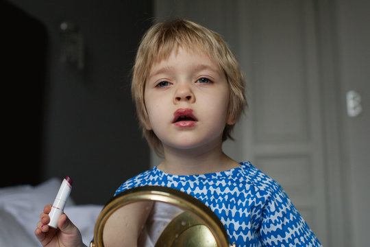 A first attempt to apply lipstick.