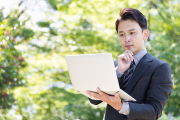 asian businessman in park