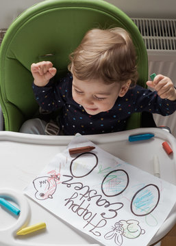 Happy Child Colouring Easter Eggs