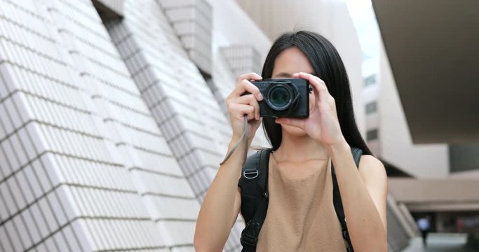 Young Woman taking photo with digital camera