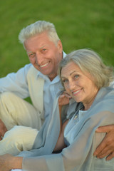  senior couple sitting on grass