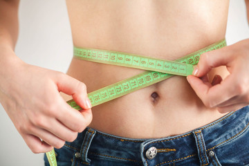 Woman checking waistline