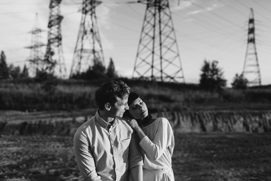 Young couple walking  ander the power lines