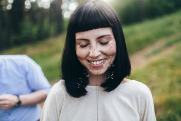 Young smiling girl holding the herb