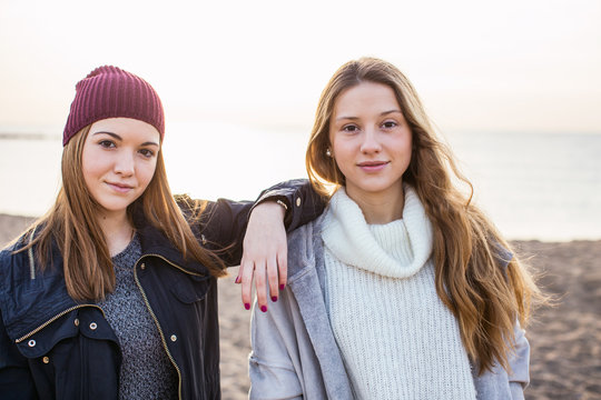 Portrait of young women standing on the beach at morning.