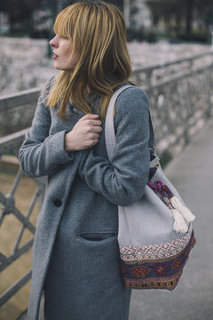 Young fashionable woman walking on the street