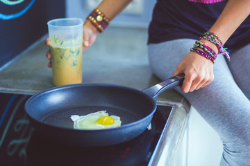 Fitness girl cooking healthy food in the kitchen. Woman. Kitchen. Cooking