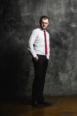 young man in glasses standing in white shirt