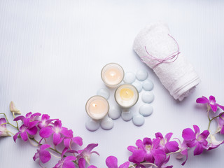 Spa still life concept,Close up of spa theme on white wood background with burning candle and orchid