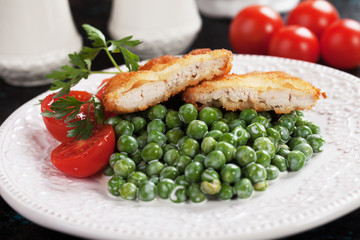 Breaded chicken steak with green peas