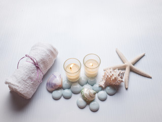 Fototapeta na wymiar Spa concept on the beach, Spa with candle and starfish shell on with wood background
