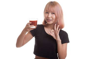 Young Asian woman show OK with tomato juice.