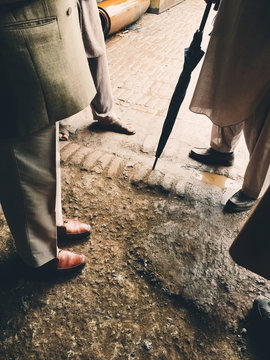 Feet Of A Group Of Men Standing And Talking