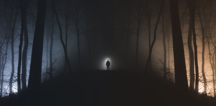 Man in surreal haunted forest on Halloween night