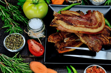 pork meat with vegetables on table