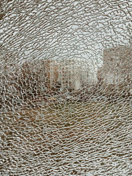 Cracked broken destroyed glass damaged window background; background for mobile