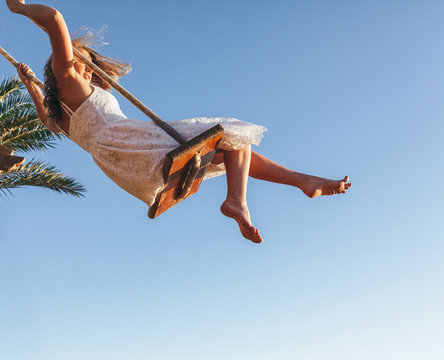 Young woman riding on a swing