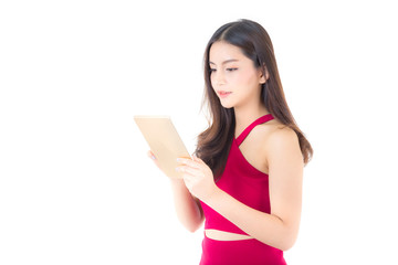 Smiling asian woman in red dress looking tablet , girl look and holding tablet isolated on white background.