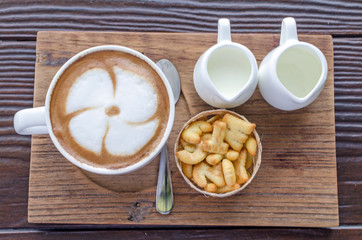coffee latte art on wood table in cafe, selective focus top view