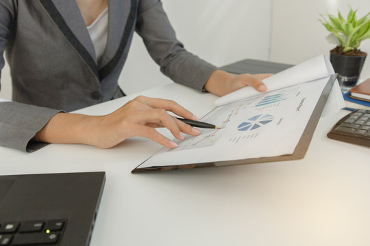 Businessman check profit document and calculate about and note data cost at home ,Finance managers task,Currency investment that think carefully. Concept business and finance