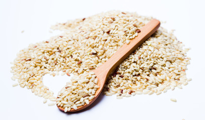 Yellow rice seeds in a wooden spoon