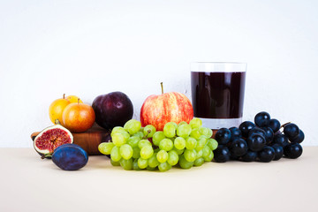 Grape juice with autumn seasonal fruits.