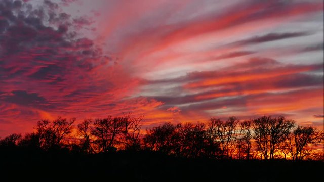 Bright red sky during texas sunset in time lapse.