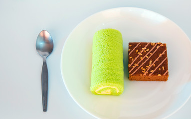 Pieces of caramel coffee cake and pandan flavor roll cake