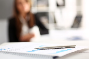 Silver pen lying on important paper at table
