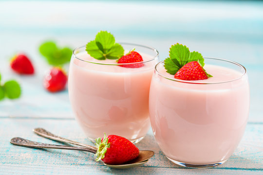 Two Glasses Of Pink Yogurt On A Wooden Background