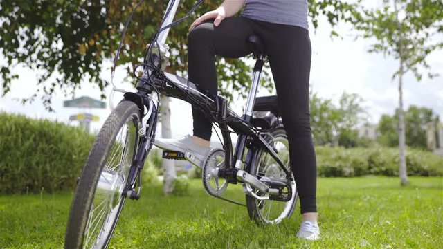 Person sit on electric bicycle low angle view 4K