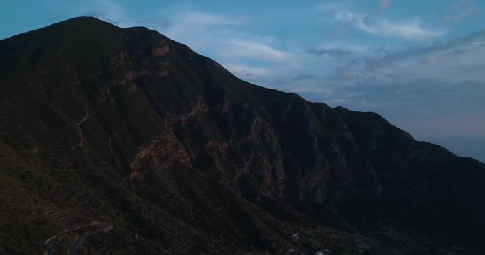 panning aerial view of mediterranean sea Salina volcano mountain and Pollara town.Nature outdoors travel establisher,Italy,Sicily Eolian Island.Summer or spring.4k drone establishing video