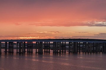 Fototapeta na wymiar View of the sunset behind a bridge in Pert Amboy, New Jersey.