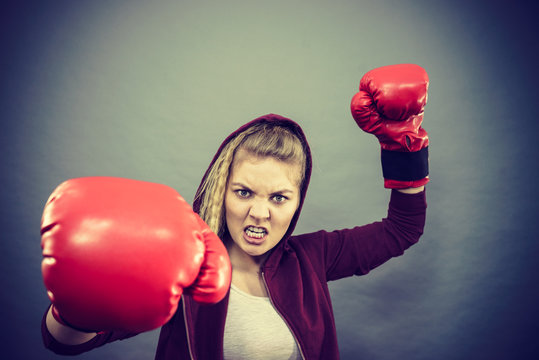 Angry woman wearing boxing gloves