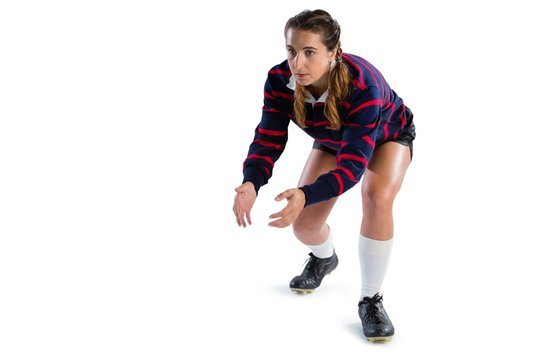Full length of female rugby player in catching position - Powered by Adobe