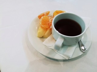 A cup of coffee and fresh fruit. Picture with copy space