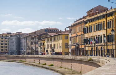 Fototapeta na wymiar The colorful riverside of River Arno in the city of Pisa