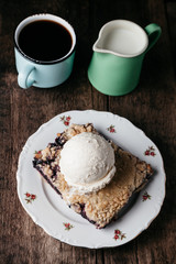 Homemade fresh blueberry pie with ice-cream on rustic background
