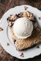 Homemade fresh blueberry pie with ice-cream on rustic background