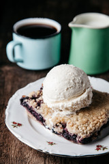 Homemade fresh blueberry pie with ice-cream on rustic background