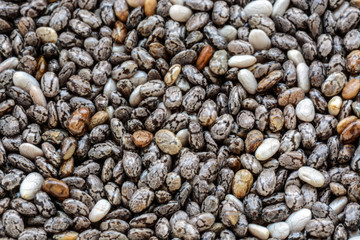 Close-up macro background of whole dried organic chia seeds