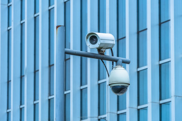 close-up view of security camera, in front of office building..