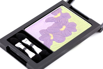 isolated makeup set: box of eye shadows, green and violet color on white